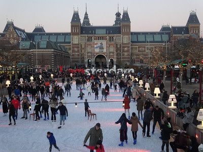 Museumplein during the winter with ice skaters in the ice rink.