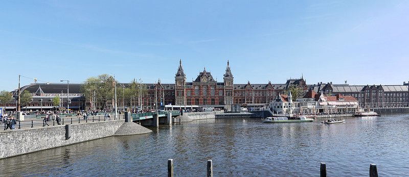 An over view of Amsterdam Centraal Station by the water.