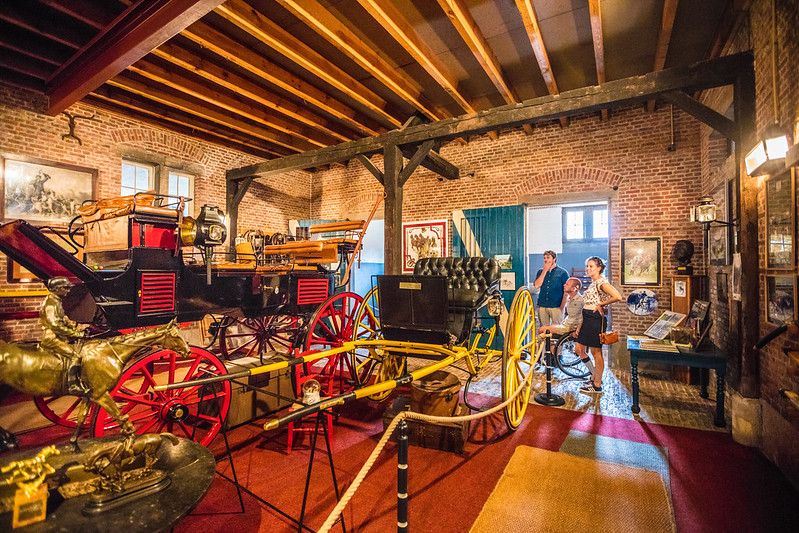 Tourists viewing the carriage collection in Bornem Castle, Belgium
