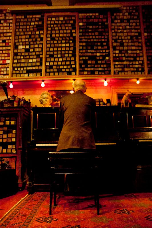 Man playing inside the Geelvinck Pianola Museum, Amsterdam, Netherlands