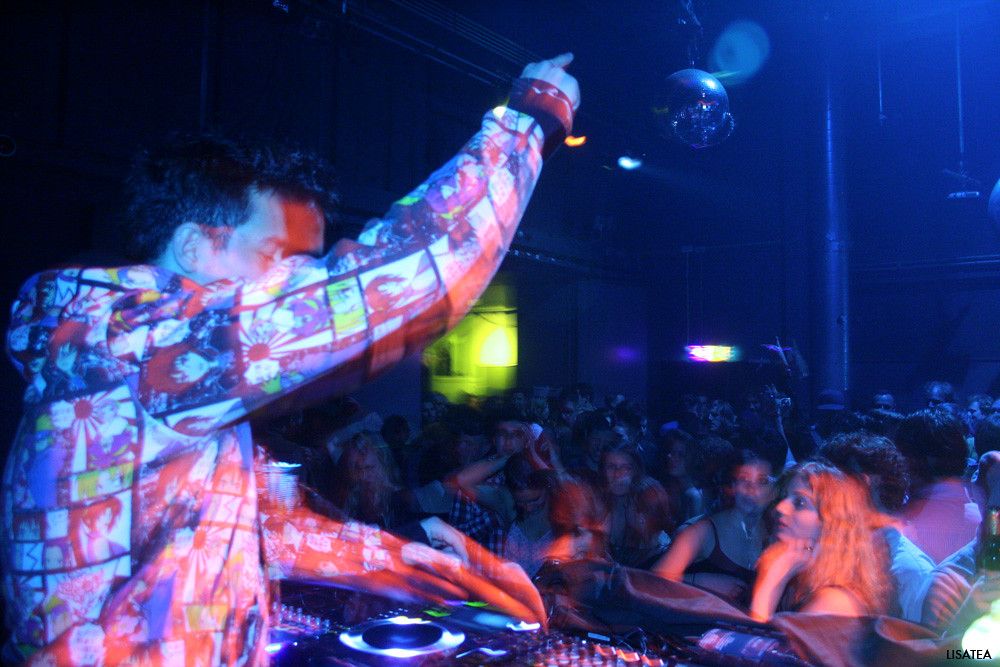 DJ pointing his hands up to the crowd while spinning music in the OT301 club