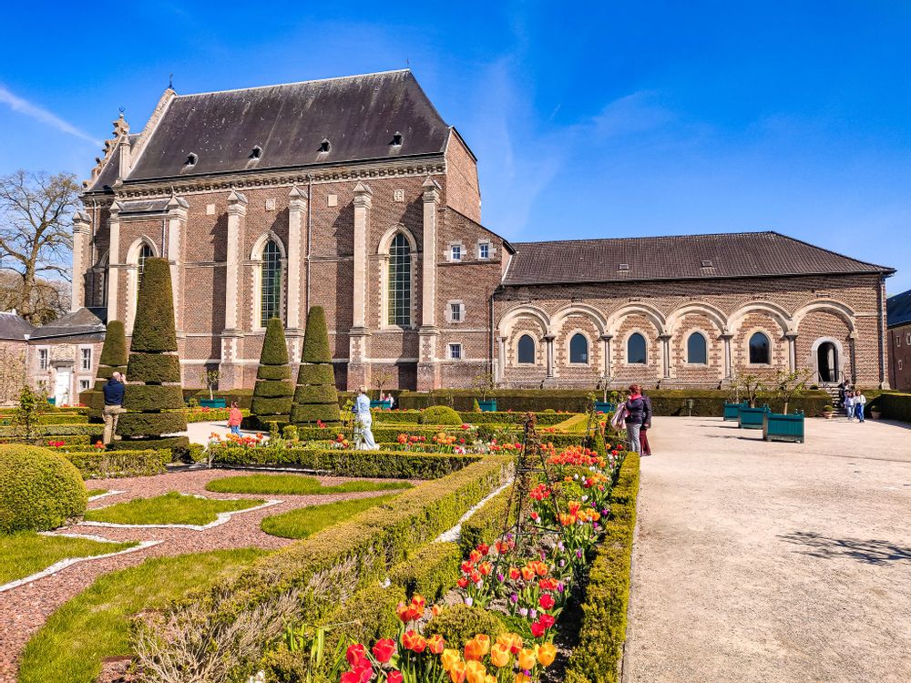 Courtyard garden with flowers at castle Alden Bisen, Belgium 