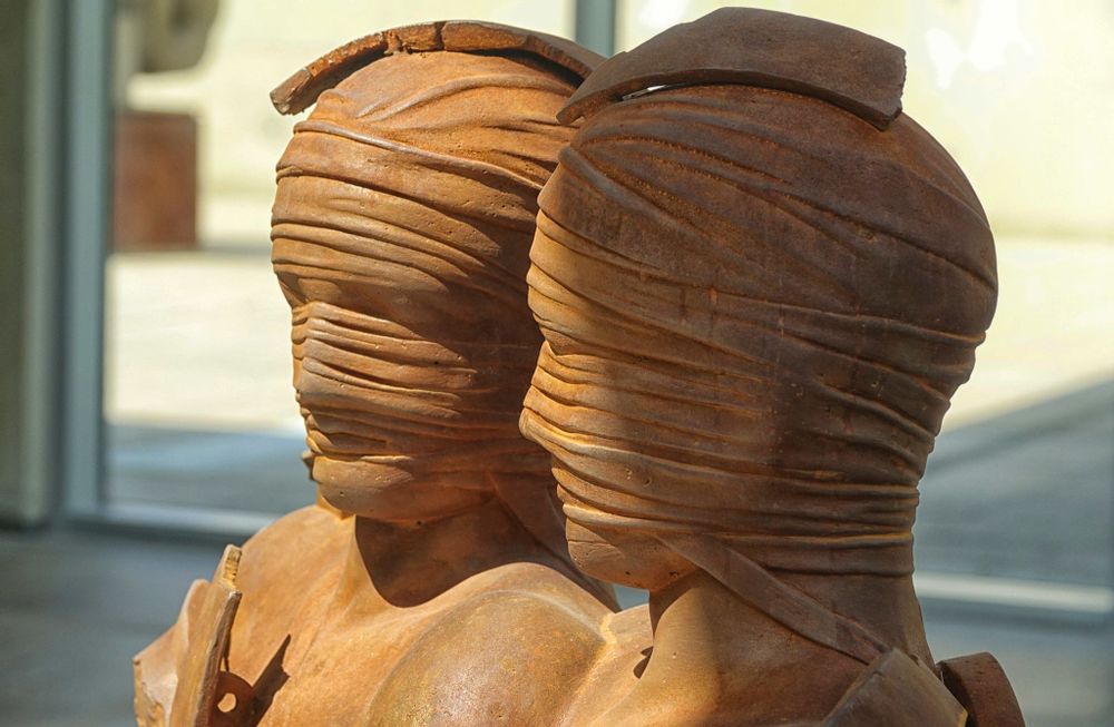 Two bronze statues stand in the sculpture garden at Beelden aan Zee.