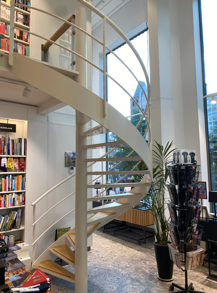 Broese Booksellers stairwell by shelves of books.