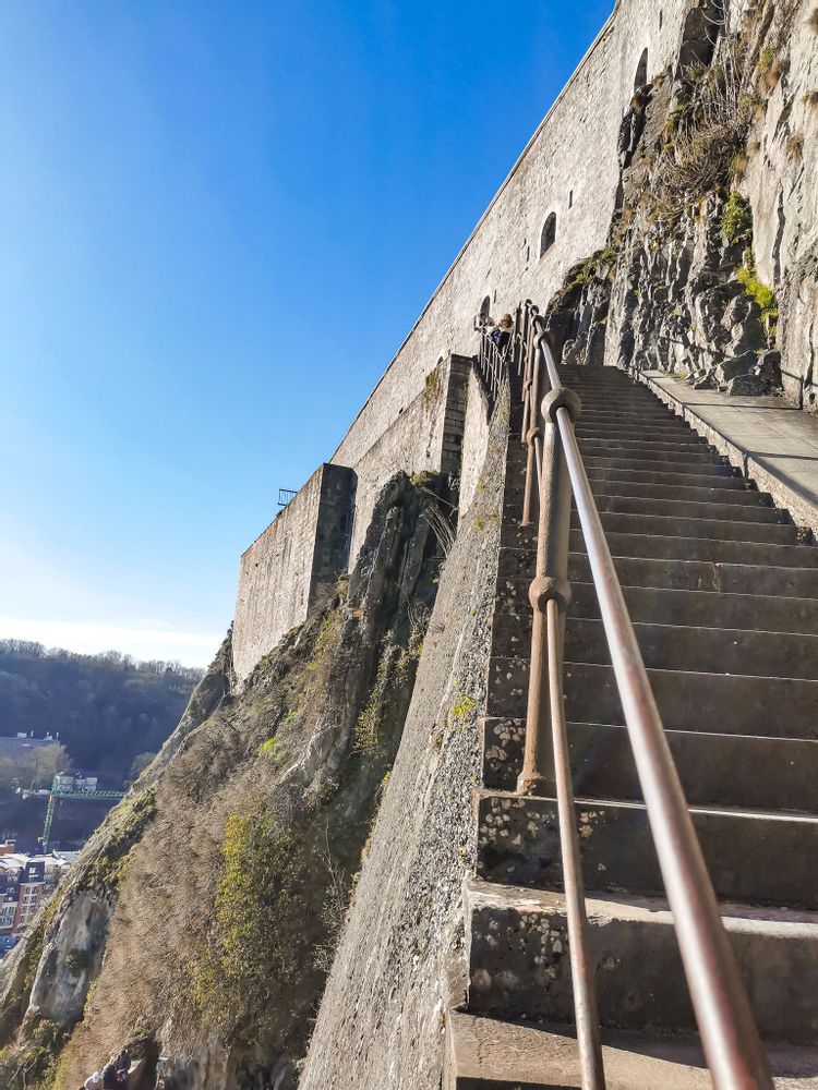 Walking up the stairs by the wall of the Citadel of Dinant, Namur, Belgium