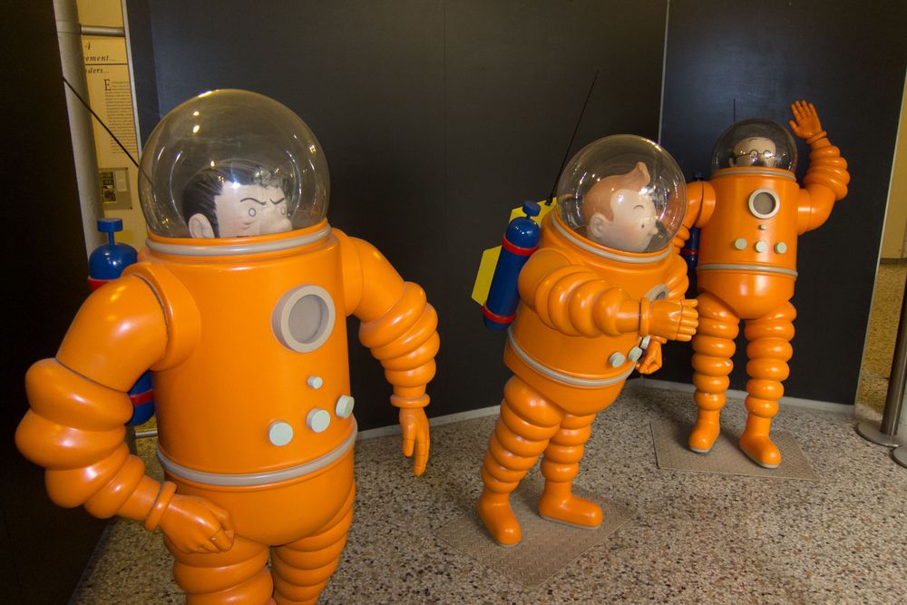 Small statues of TinTin characters in spacesuits at the Comics Art Museum, in Brussels.