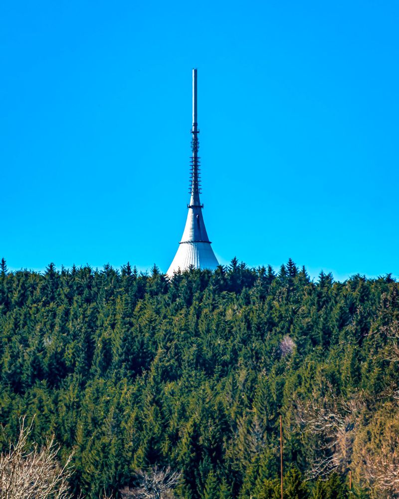 White tower in the distance surrounded by trees, Jested in Liberec