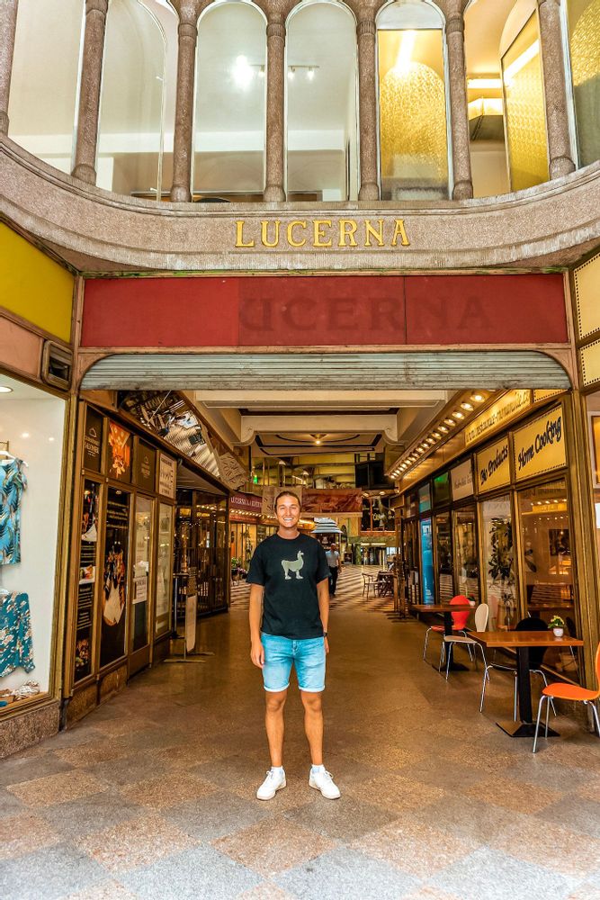 Man standing at the entrance of a shopping area in Prague, Czechia