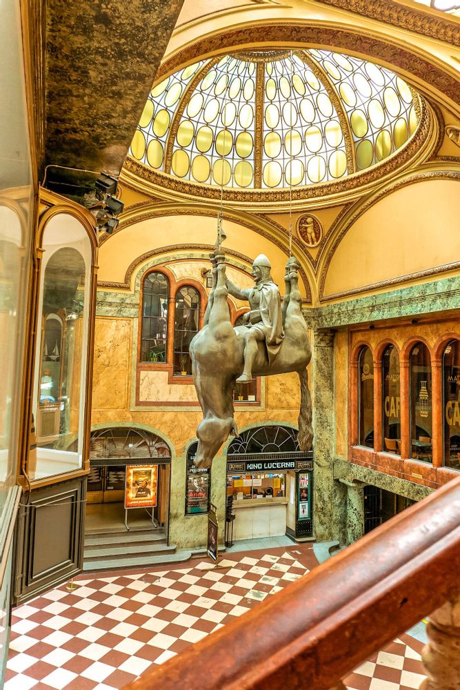 Man on a horse statue hanging from the ceiling in Lucerna Passage, Prague