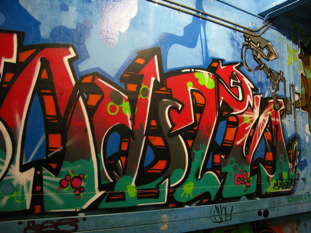 Graffiti art spray painted on a blue wall at cultural events house OT301