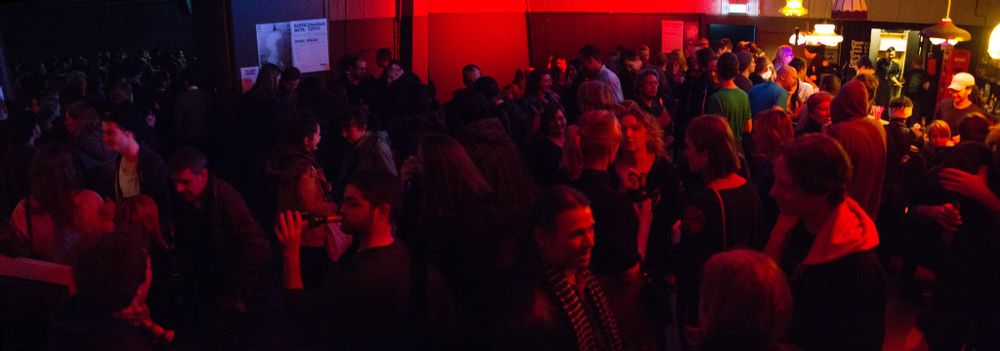 OT301 packed with people drinking and listening to music 