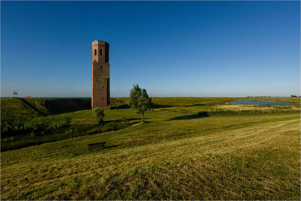 The brick Plompe Tower stands in the middle of a field in Zeeland, Netherlands.