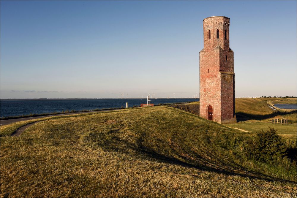 Plompe Tower sits behind the bank of the sea in Zeeland, Netherlands.