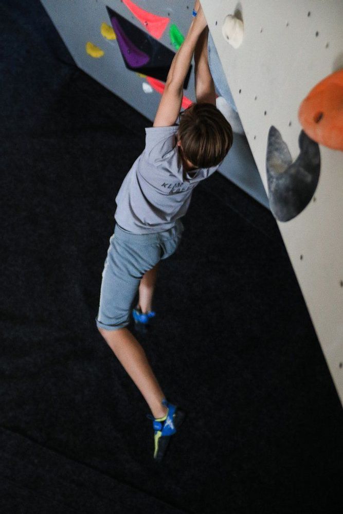 A child hanging while rock climbing