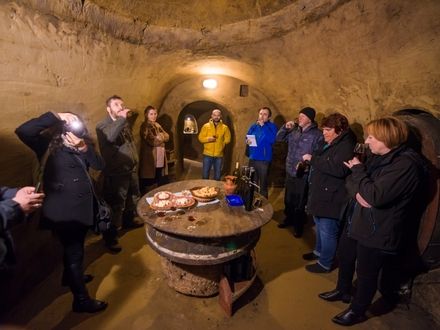 A group of people having a wine tasting inside the Turnip Caves.