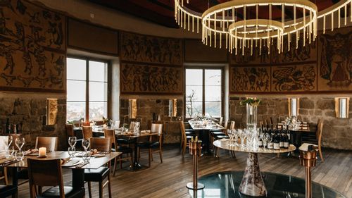 The wide and curved interior Strelec Restaurant hosted in a castle tower. 