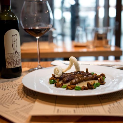 A plate of Slovenian tapas and a glass of wine at TaBar.