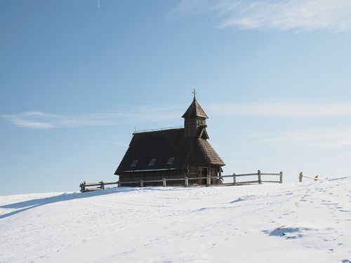 The church in Velika Planina during the winter time with fresh snow all around.